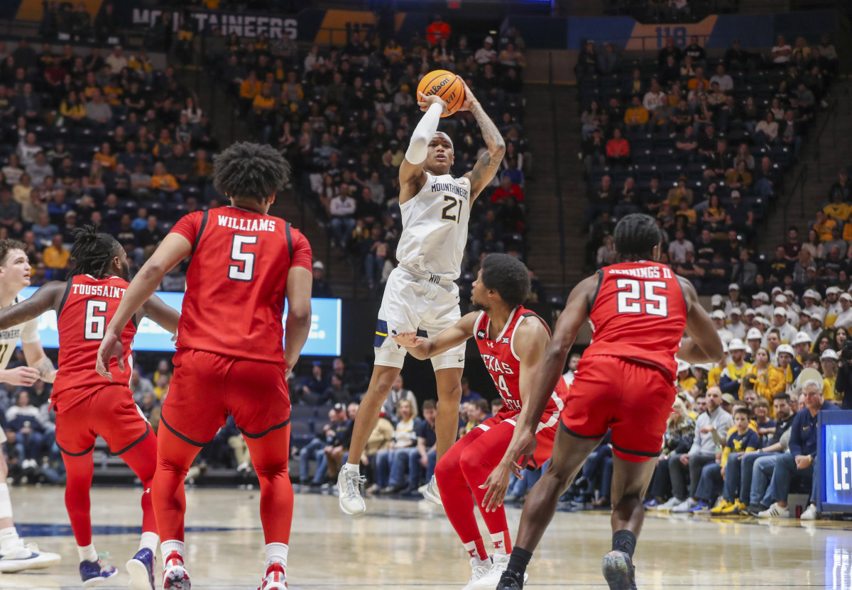 Mountaineers guard RaeQuan Battle (21) shoots a jumper over Texas Tech Red Raiders guard Kerwin Walton (24) during the second half at WVU Coliseum. Mandatory Credit: Ben Queen-USA TODAY Sports